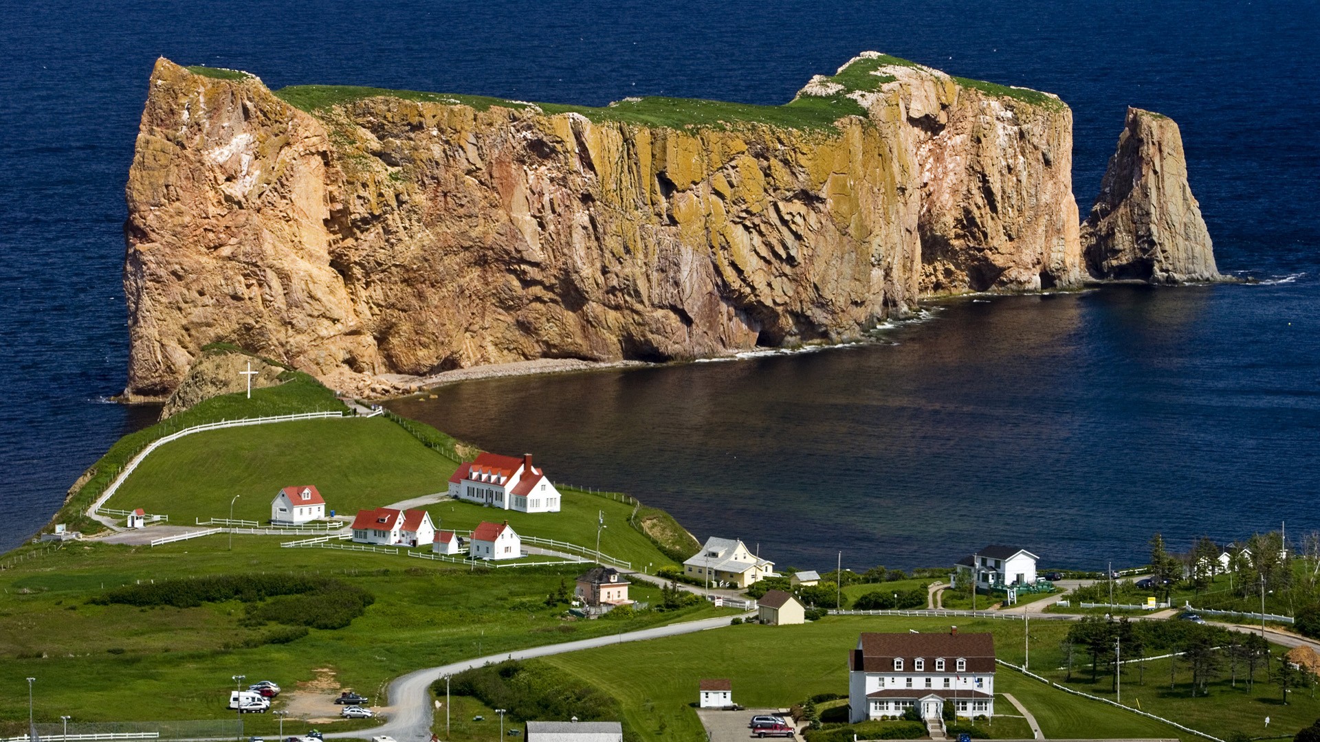  Rocher Percé or Percé Rock was so named by Samuel de Champlain in 1607.  Forming the tip of the Gaspé  Peninsula, it marks the entrance to the Gulf of St. Lawrence.  The surrealist poet André Breton described it as "razor blade rising out of the water... a marvelous iceberg of moon stone"
