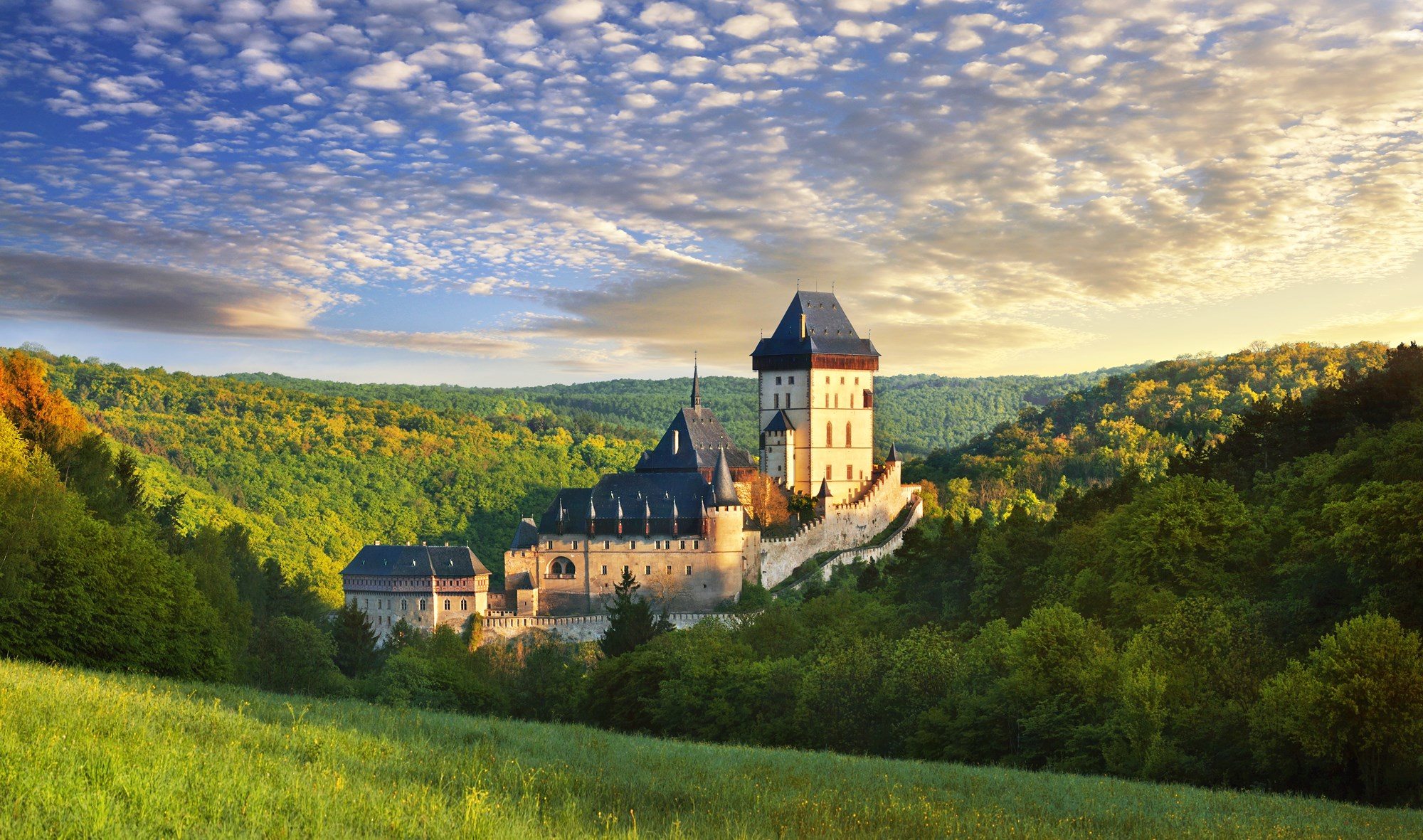 Hrad Karlštejn (Karlštejn Castle), just outside Prague, Czech Republic.  Founded under Charles IV of Bohemia when he was elected Holy Roman Emperor.  There is a tradition that he had the miners who constructed its underground water reservoir murdered so that none could reveal its existence.  